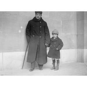   Blind Sen. Thos. D. Schall led by his 6 year old son