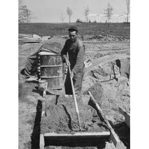  Man Mixing Cement as Part of His Duties as an Apprentice 