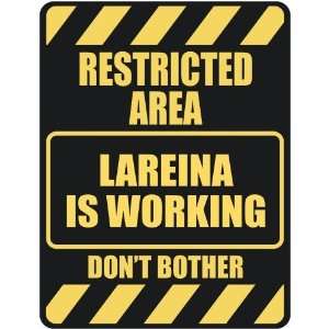   RESTRICTED AREA LAREINA IS WORKING  PARKING SIGN