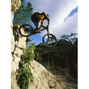  Man Jumping on His Mountain Bike with Ha Ling Peak in the 